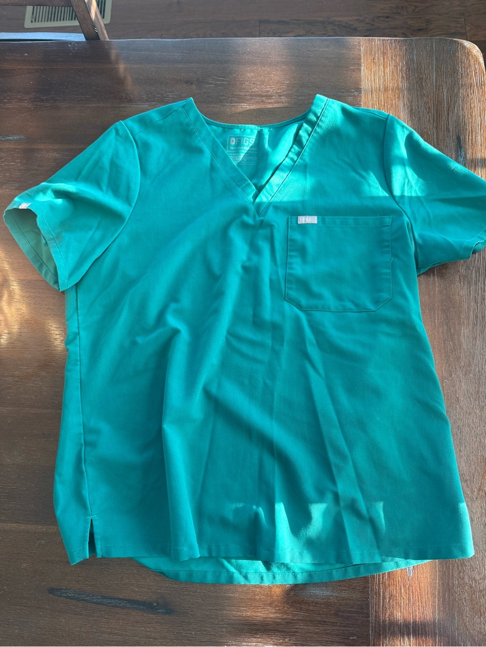 FIGS Technical Collection scrub top in Hunter Green, size XL.